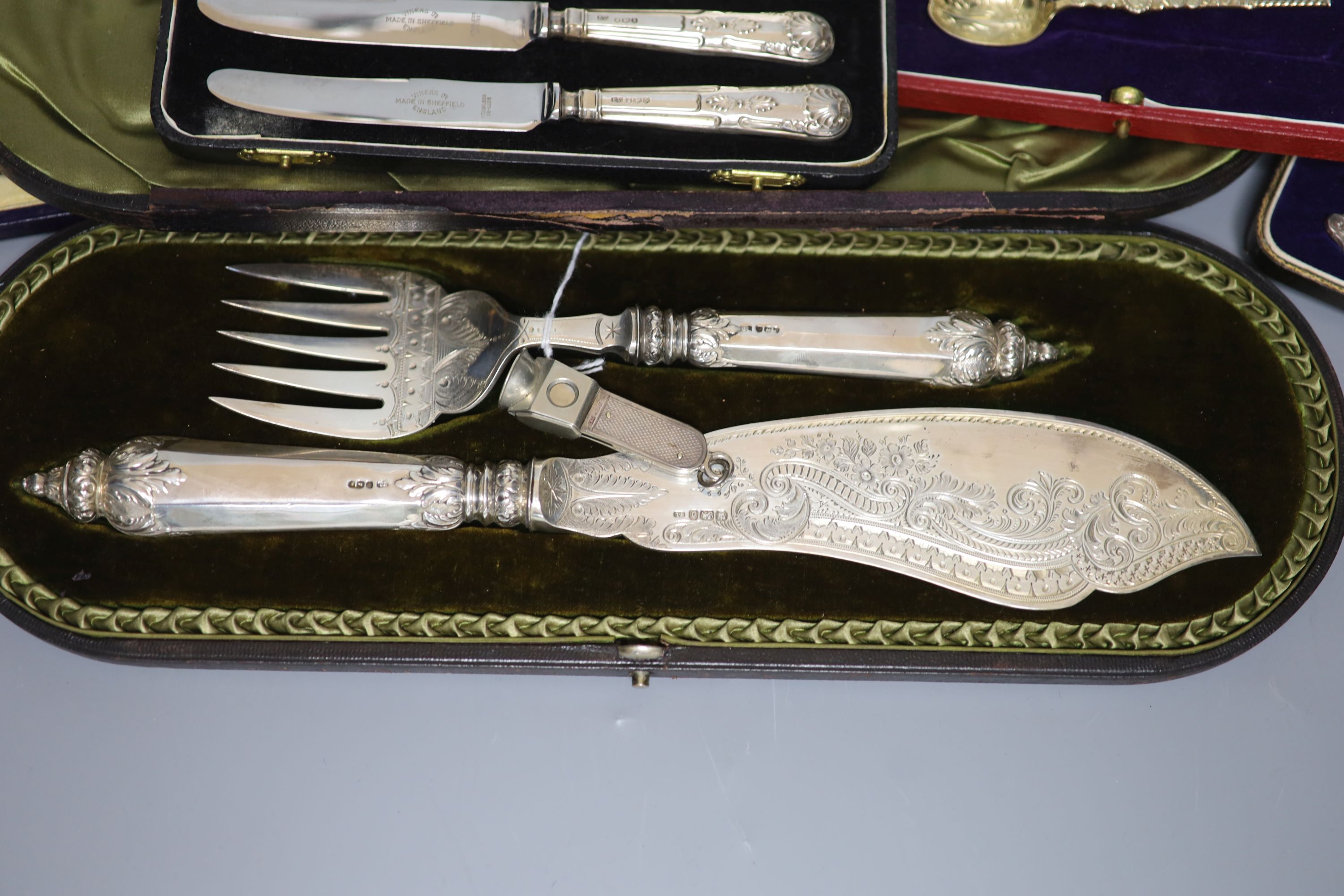 Mixed silver including cased pair of late Victorian silver fish servers, four other cased sets and a silver mounted cigar cutter.